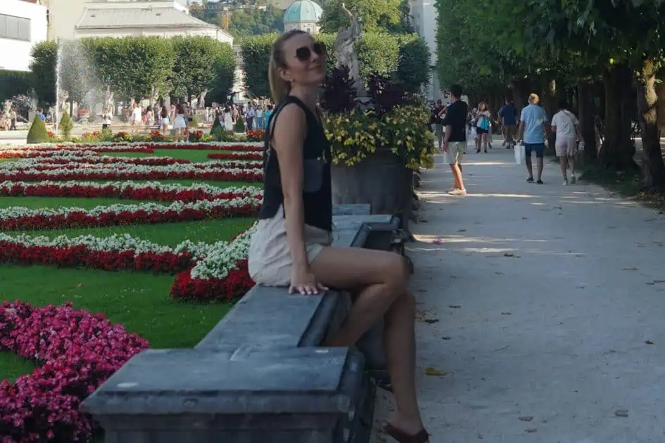 A lady sitting and smiling in Mirabel Gardens, Austria