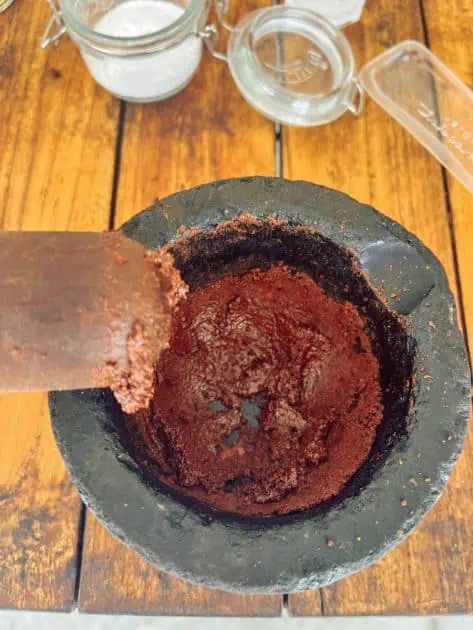 step one of making chocolate at Project chocolat is grinding in hot mortar