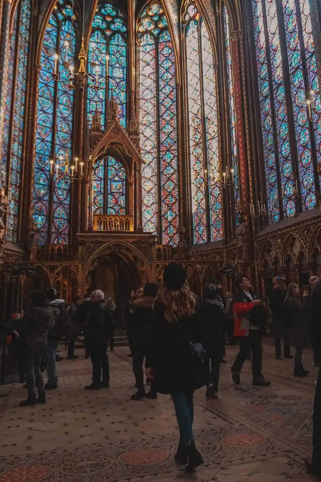 Girl exploring the inside of Sainte Chapelle Paris