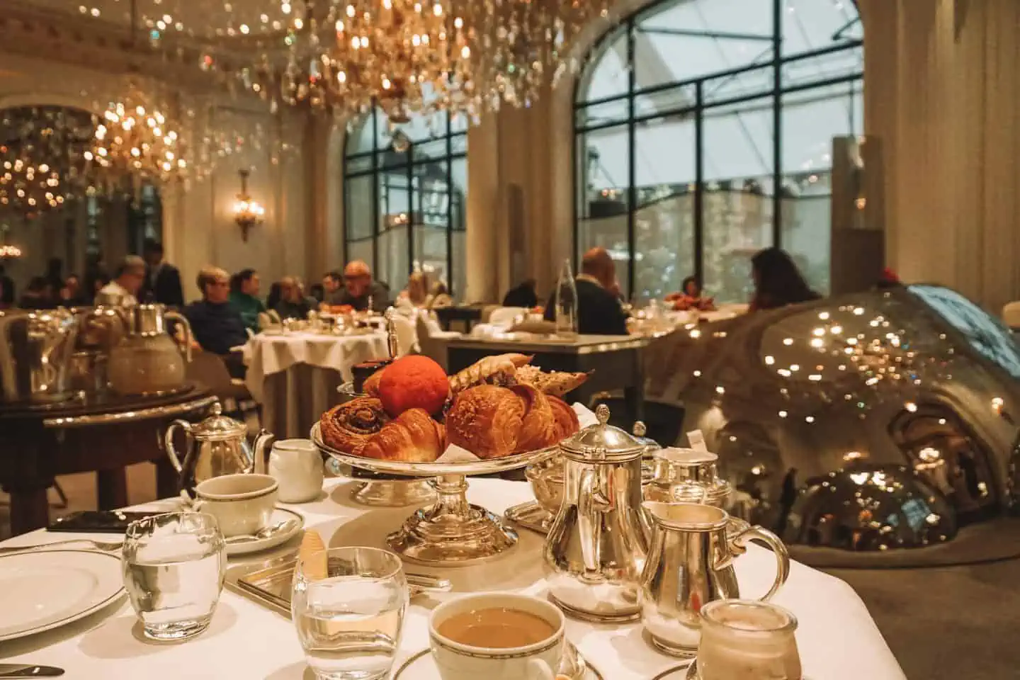 Breakfast table featuring croissants, pastries and coffee: One week in Paris