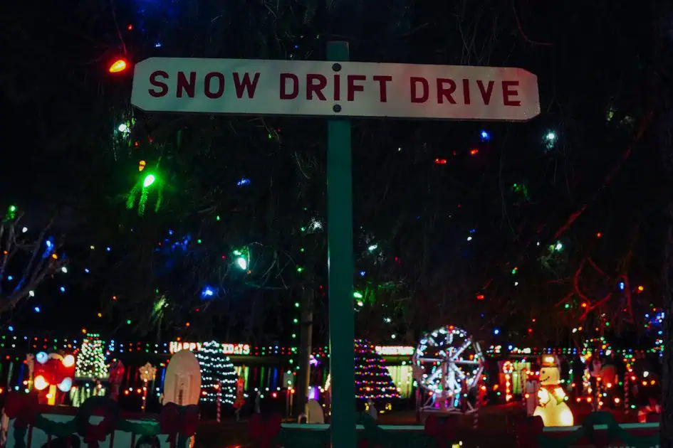 A large sign "Snow drift drive" with the background of sparkling village